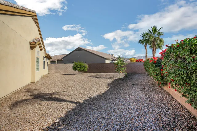 a living room with patio furniture and garden view