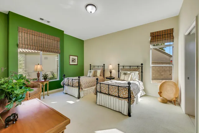 a bedroom with furniture and a potted plant