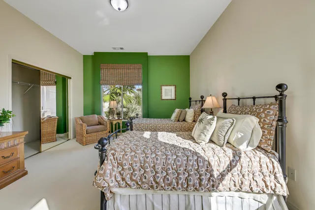 a bedroom with a large bed and a couch