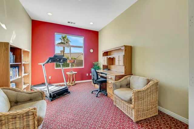 a living room with furniture a rug and a floor