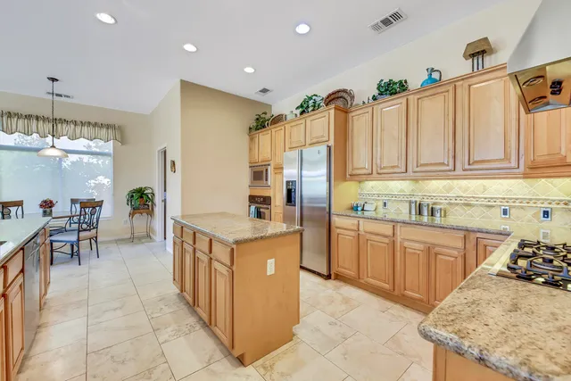 a kitchen with stainless steel appliances granite countertop a sink and cabinets