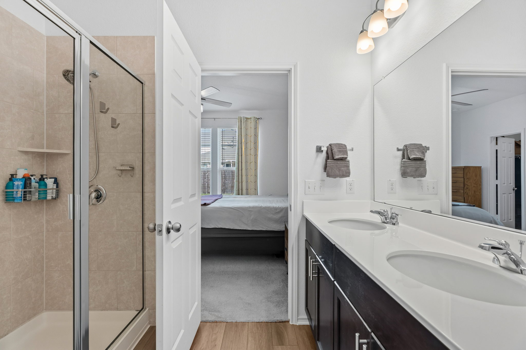 1600 Hope Rnch Road Leander, TX 78641 - Photo 15 of 23 a en suite bathroom with a double vanity sink a mirror and a shower
