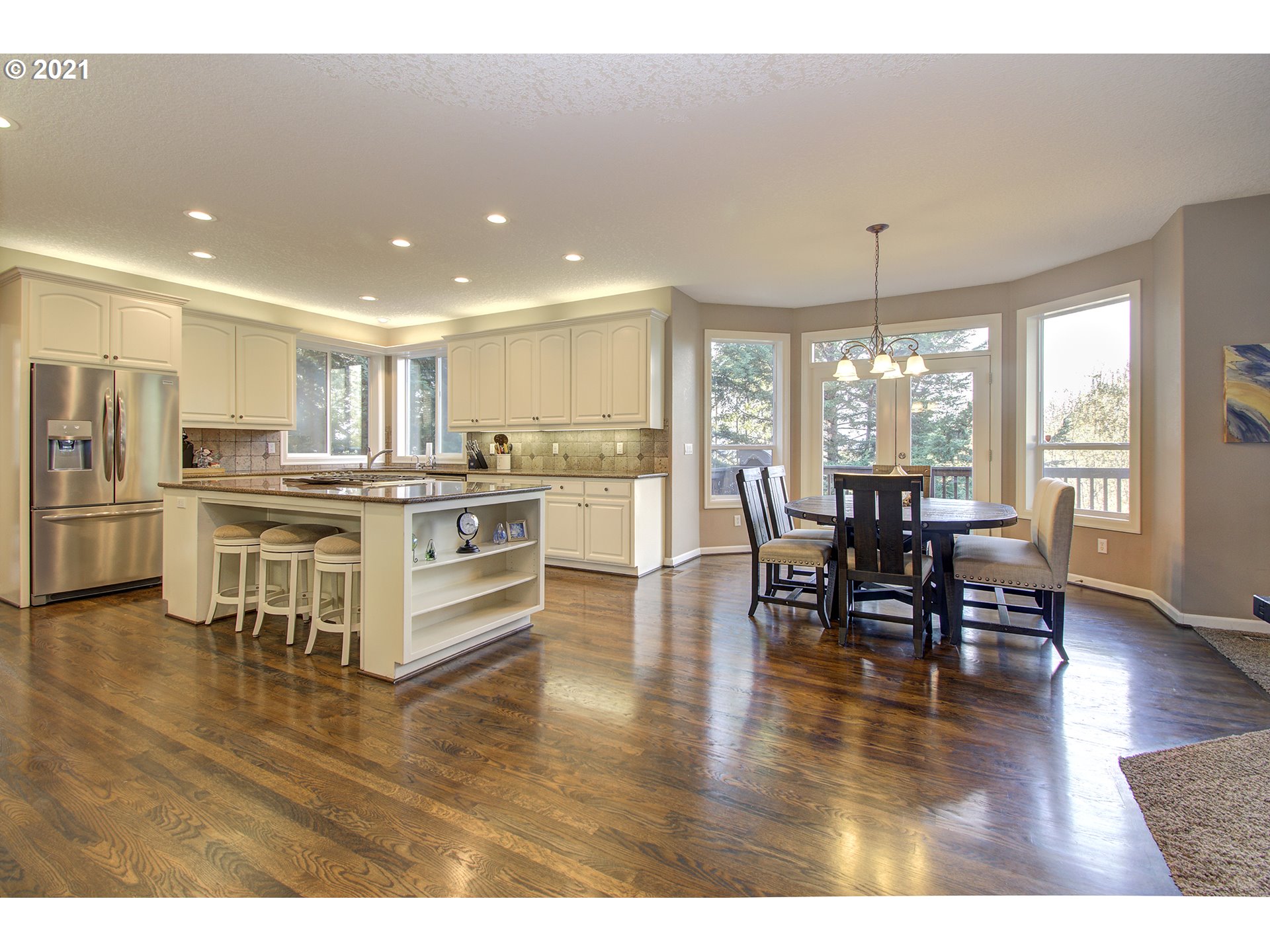 16010 Northeast 25th Avenue Ridgefield, WA 98642 - Photo 13 of 32 a kitchen with stainless steel appliances wooden floors and dining table