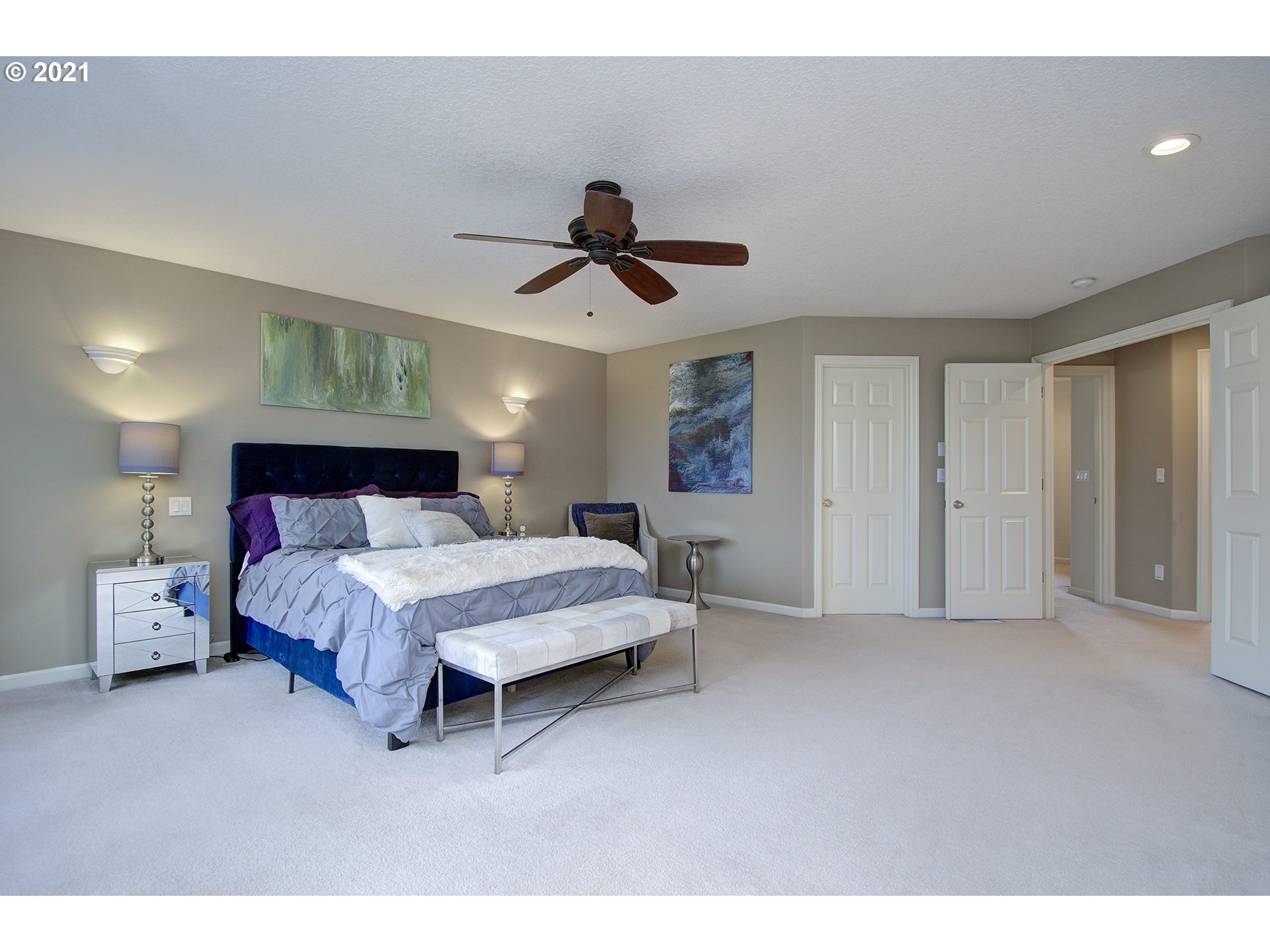 16010 Northeast 25th Avenue Ridgefield, WA 98642 - Photo 19 of 32 a spacious bedroom with a bed and a chandelier