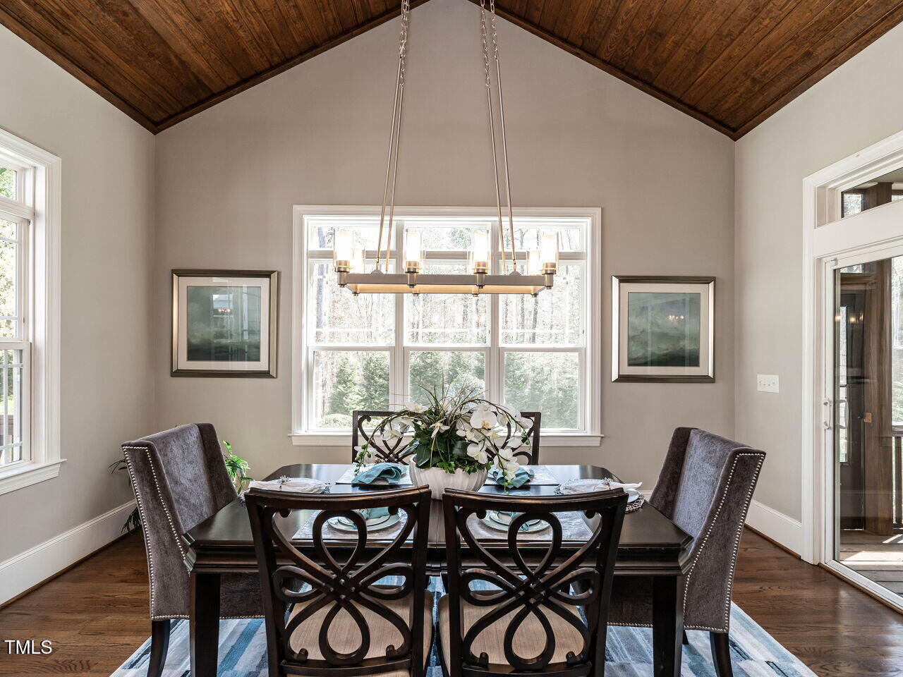 7312 Ridgeline Drive Raleigh, NC 27613 - Photo 17 of 83 a view of a dining room with furniture large windows and wooden floor