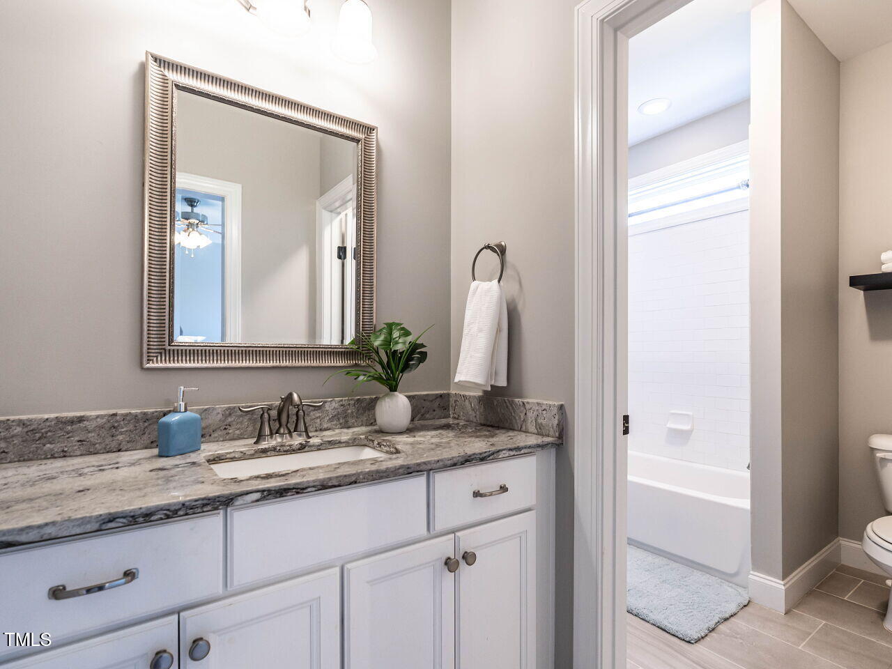 7312 Ridgeline Drive Raleigh, NC 27613 - Photo 36 of 83 a bathroom with a granite countertop sink and a mirror
