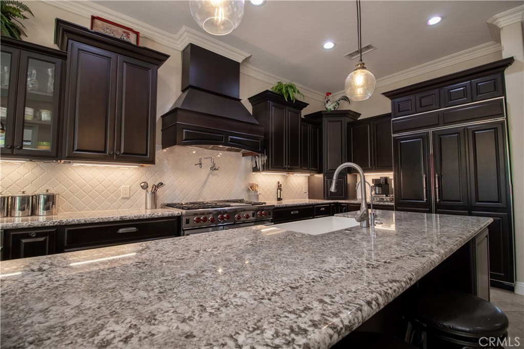 33699 Spring Brook Circle Temecula, CA 92592 - Photo 15 of 83 a kitchen with stainless steel appliances granite countertop a sink a stove and a microwave oven