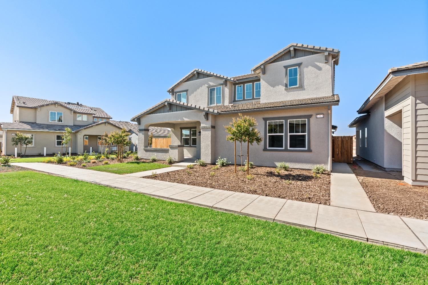 275 Huckleberry Road South Madera, CA 93636 - Photo 2 of 34 a front view of a house with a yard