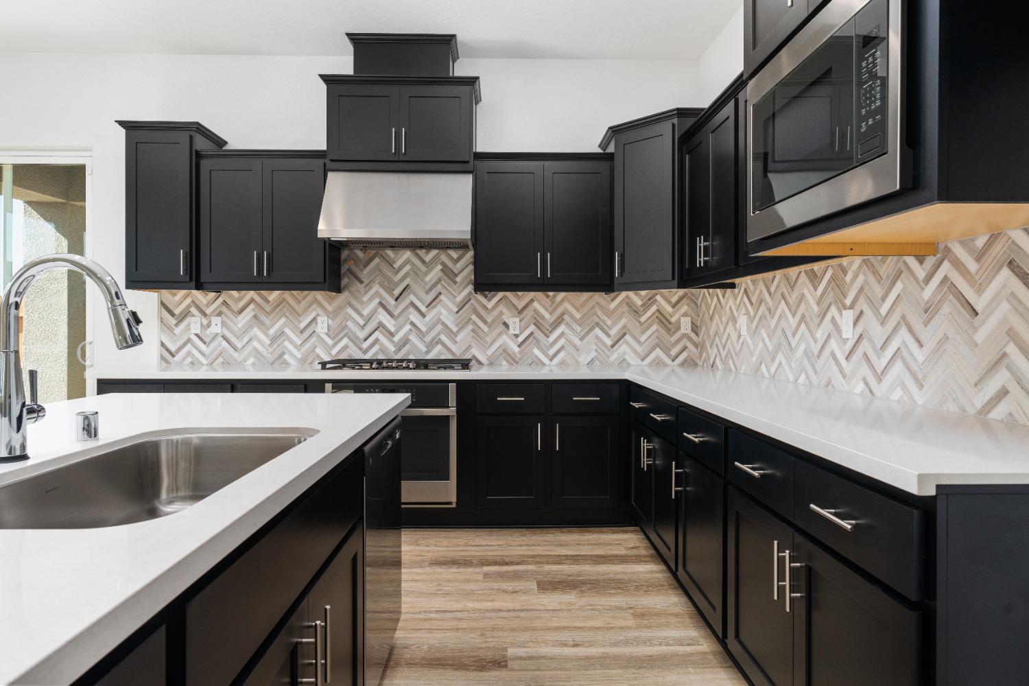 275 Huckleberry Road South Madera, CA 93636 - Photo 26 of 34 a kitchen with stainless steel appliances wooden cabinets a sink and a stove
