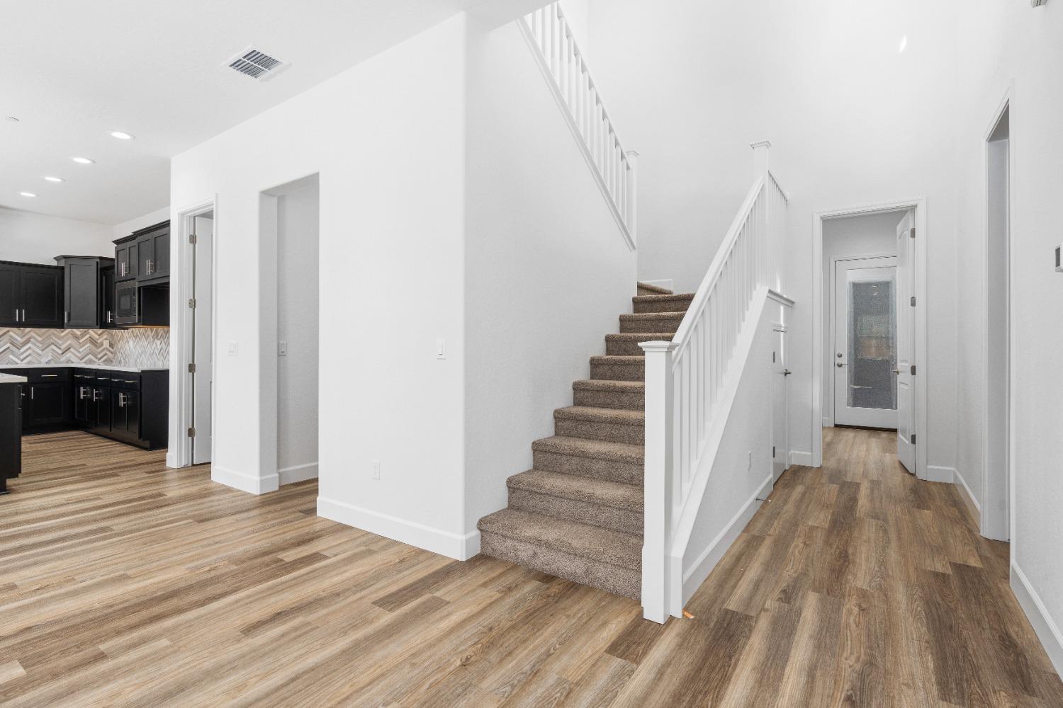 275 Huckleberry Road South Madera, CA 93636 - Photo 29 of 34 a view of a hallway with wooden floor and staircase