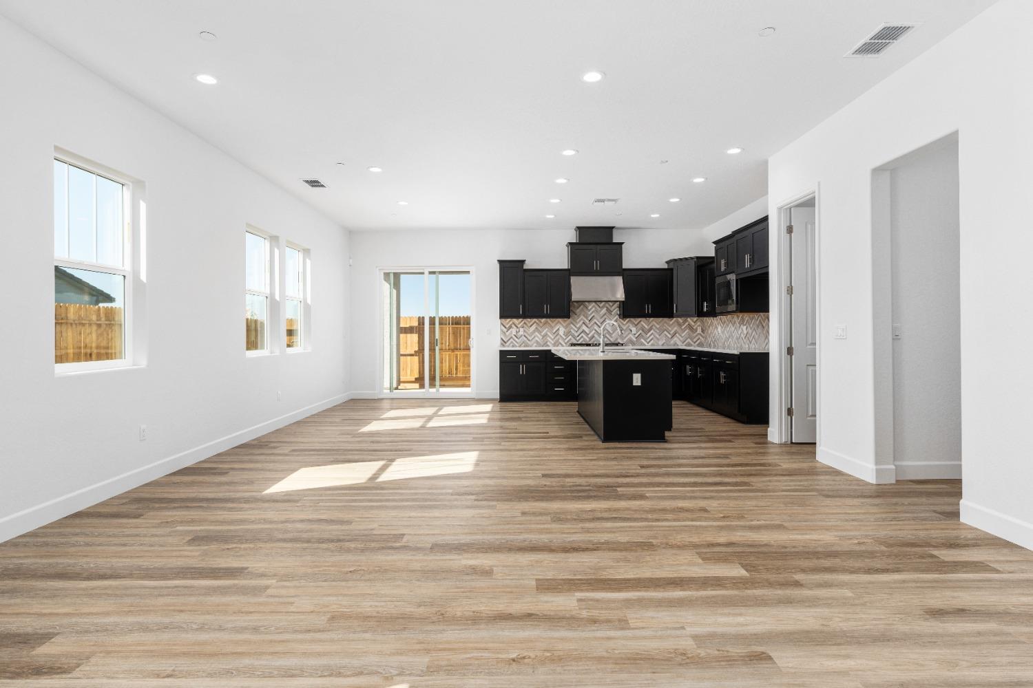 275 Huckleberry Road South Madera, CA 93636 - Photo 30 of 34 a view of kitchen with kitchen island a sink wooden floor and a living room