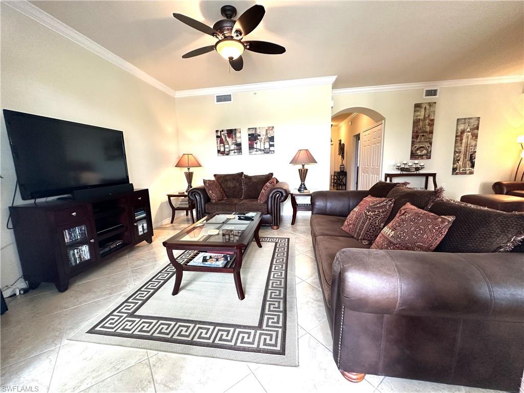 10353 Heritage Bay Boulevard, Unit 2226 Naples, FL 34120 - Photo 11 of 40 a living room with furniture and a flat screen tv