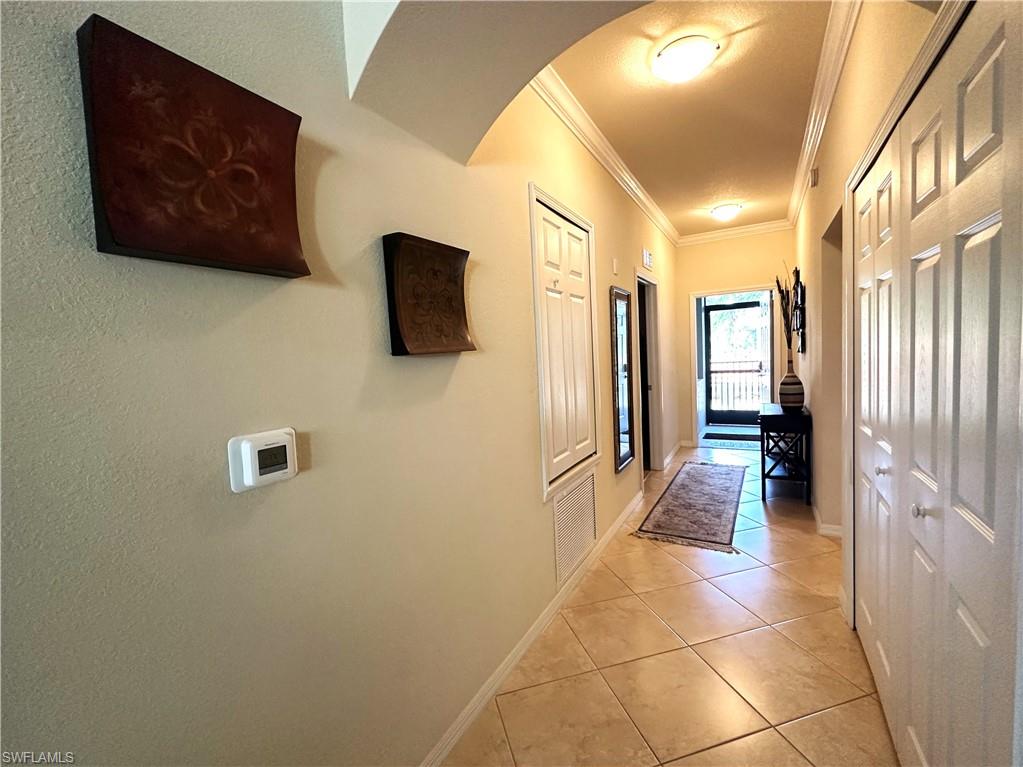 10353 Heritage Bay Boulevard, Unit 2226 Naples, FL 34120 - Photo 12 of 40 a view of a hallway with wooden floor and a cabinet
