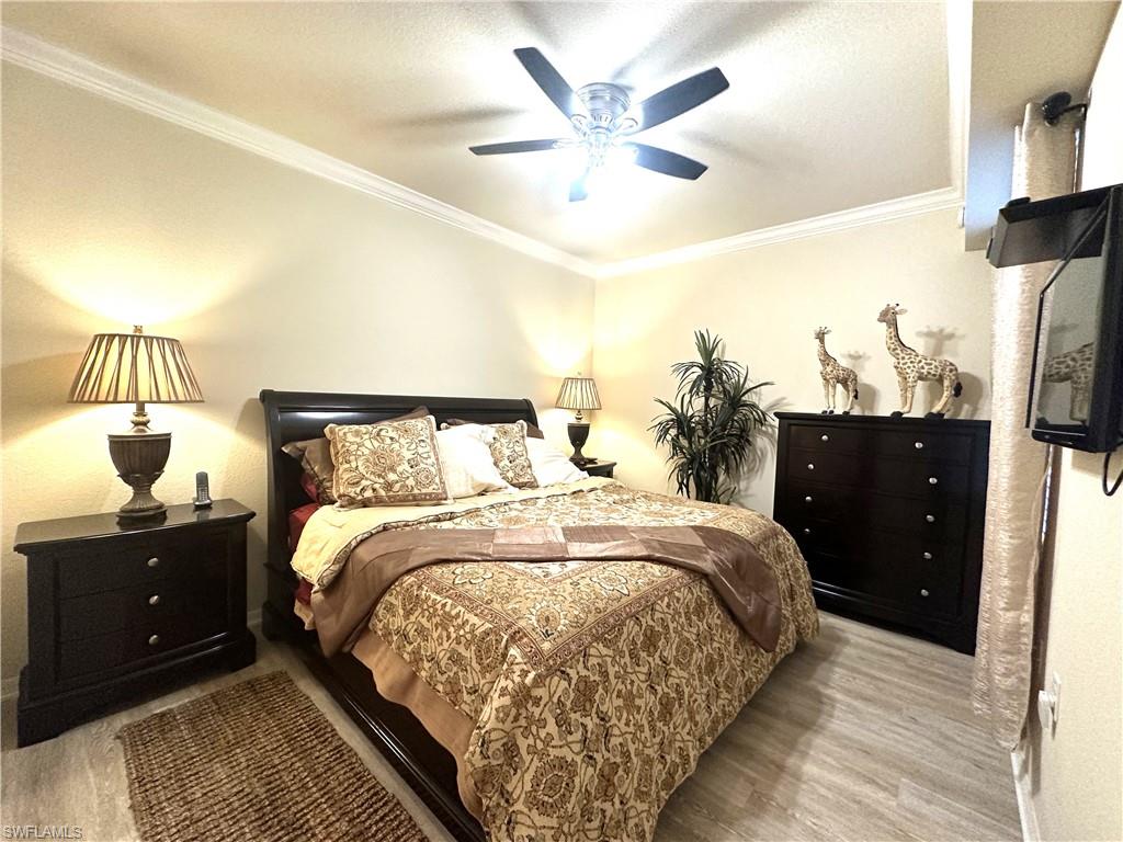10353 Heritage Bay Boulevard, Unit 2226 Naples, FL 34120 - Photo 13 of 40 a bed room with a bed and a night stand