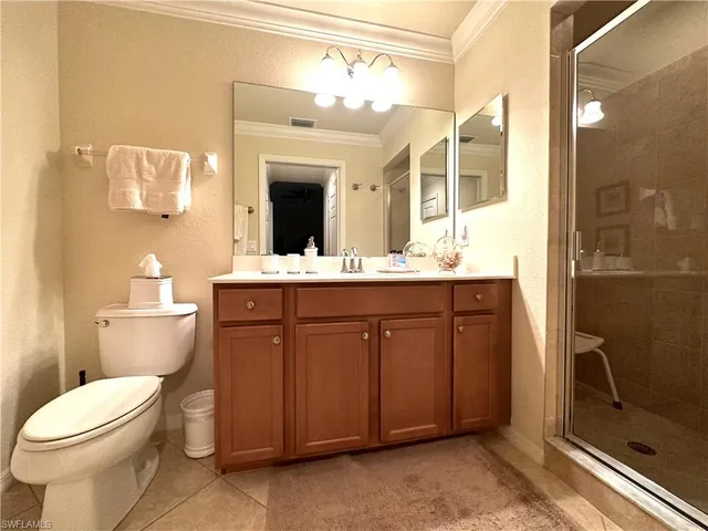 a spacious bathroom with a granite countertop sink toilet and shower