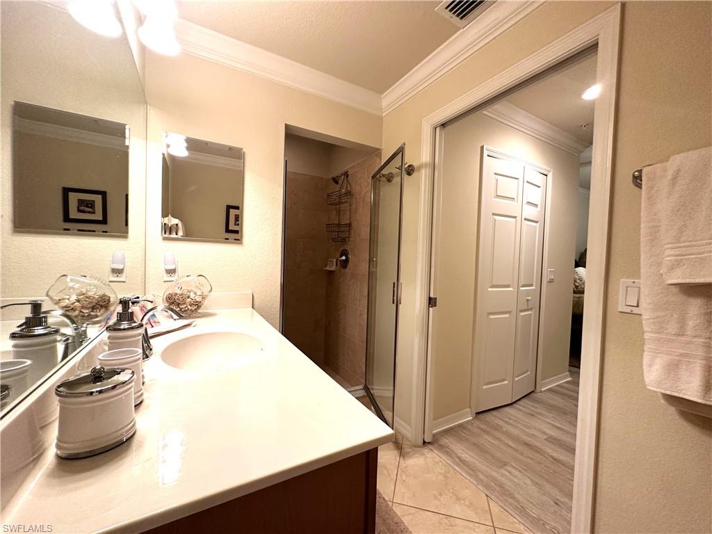 10353 Heritage Bay Boulevard, Unit 2226 Naples, FL 34120 - Photo 15 of 40 a bathroom with a sink a toilet and shower