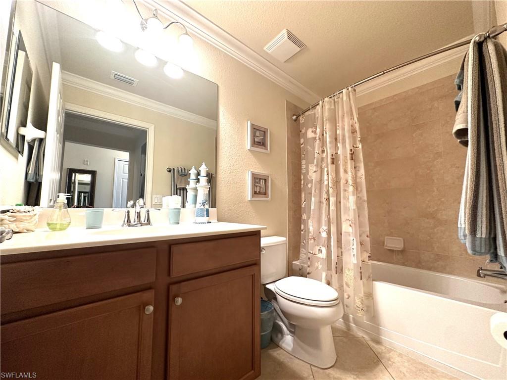 10353 Heritage Bay Boulevard, Unit 2226 Naples, FL 34120 - Photo 17 of 40 a bathroom with a toilet a sink and a bathtub