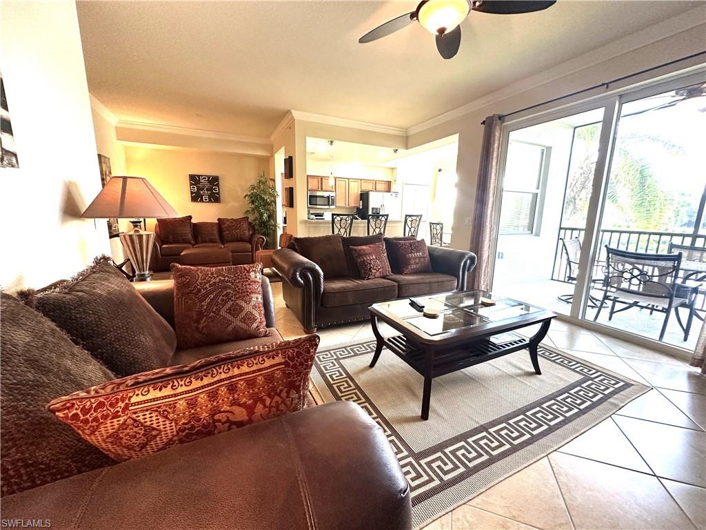 10353 Heritage Bay Boulevard, Unit 2226 Naples, FL 34120 - Photo 18 of 40 a living room with furniture and a large window