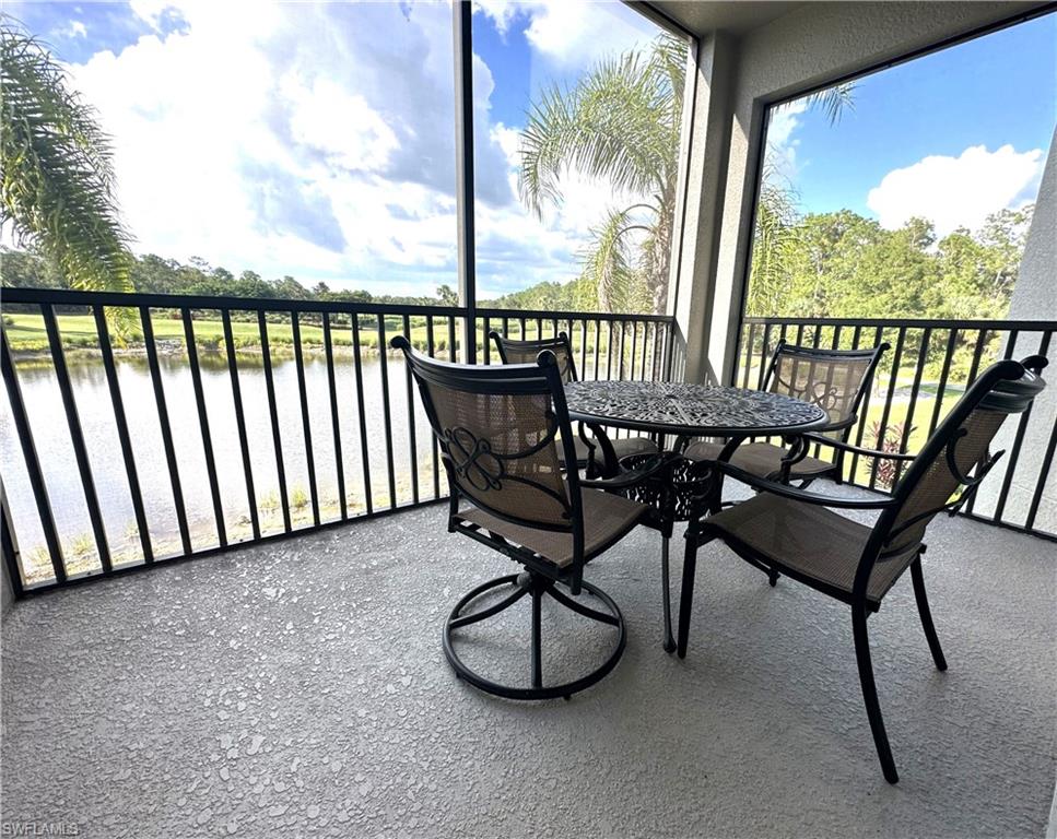 10353 Heritage Bay Boulevard, Unit 2226 Naples, FL 34120 - Photo 19 of 40 a view of a chairs and table in the porch