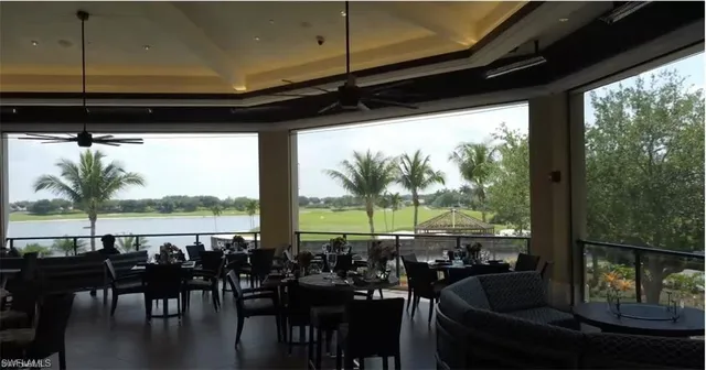 a view of a living room with furniture and floor to ceiling window