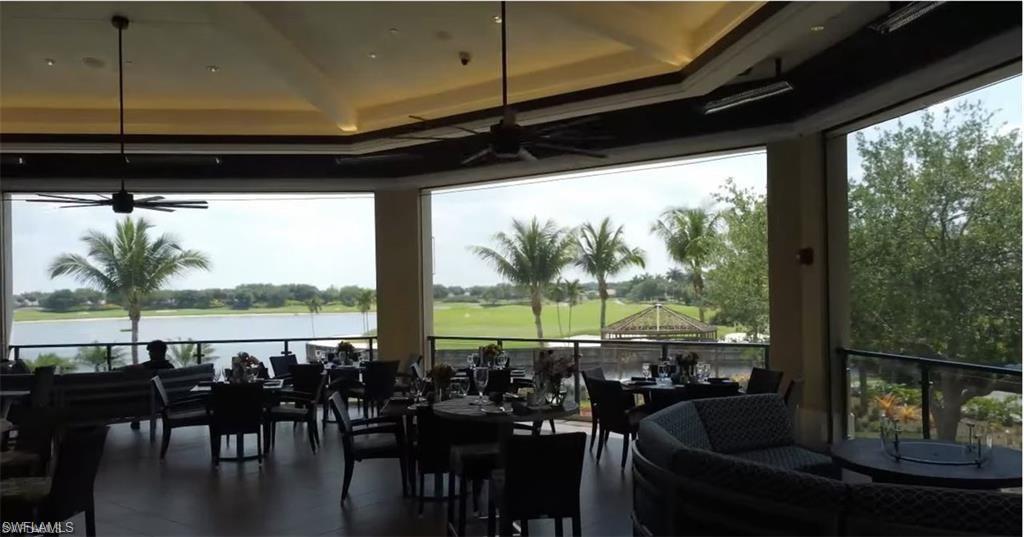 10353 Heritage Bay Boulevard, Unit 2226 Naples, FL 34120 - Photo 29 of 40 a view of a living room with furniture and floor to ceiling window