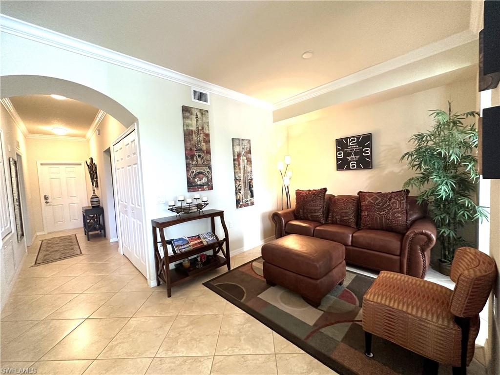 10353 Heritage Bay Boulevard, Unit 2226 Naples, FL 34120 - Photo 3 of 40 a living room with furniture and a flat screen tv