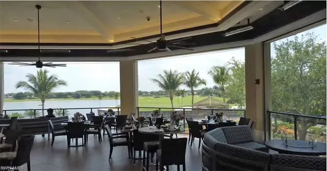 a view of a living room with furniture and floor to ceiling window