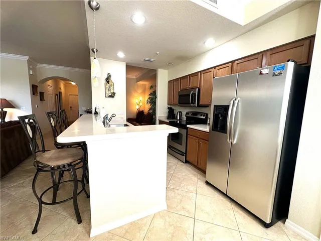 a kitchen with stainless steel appliances a refrigerator and a sink