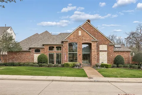 a front view of a house with a yard and outdoor seating