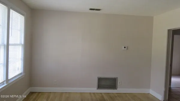 a view of an empty room with a window
