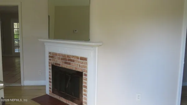 a view of an empty room with a fireplace