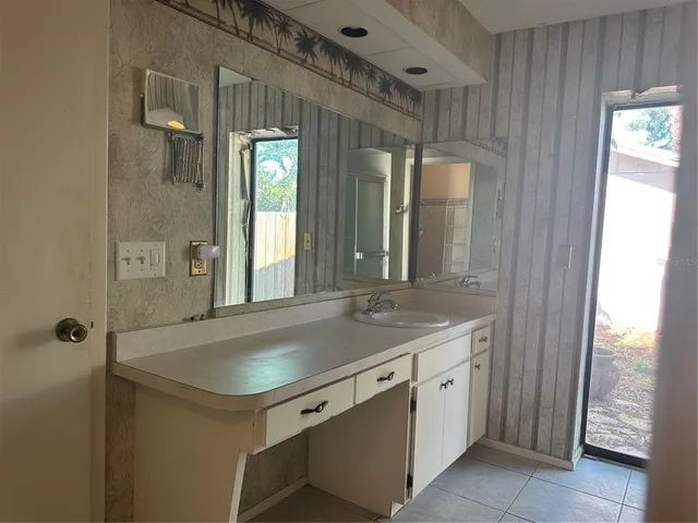 a bathroom with a sink a mirror and a bathtub