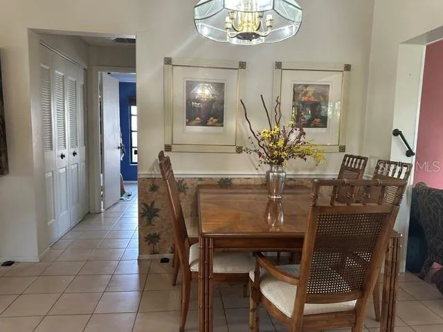 a dining room with furniture and chandelier