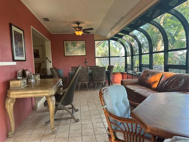 a workspace with furniture and a large window