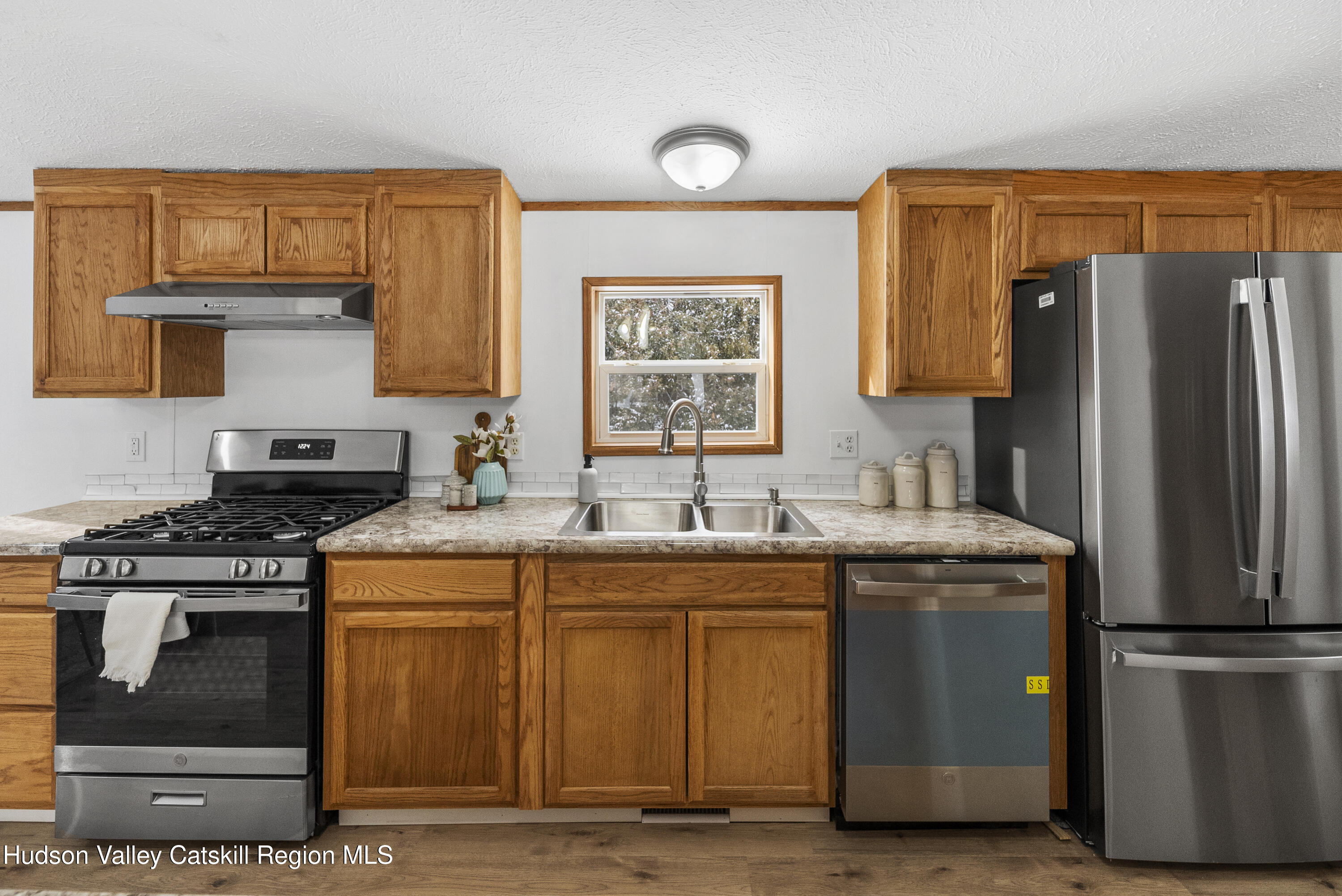 3701 Galway Road, Unit 5 Ballston Spa, NY 12020 - Photo 17 of 47 a kitchen with stainless steel appliances granite countertop a stove a refrigerator and a sink