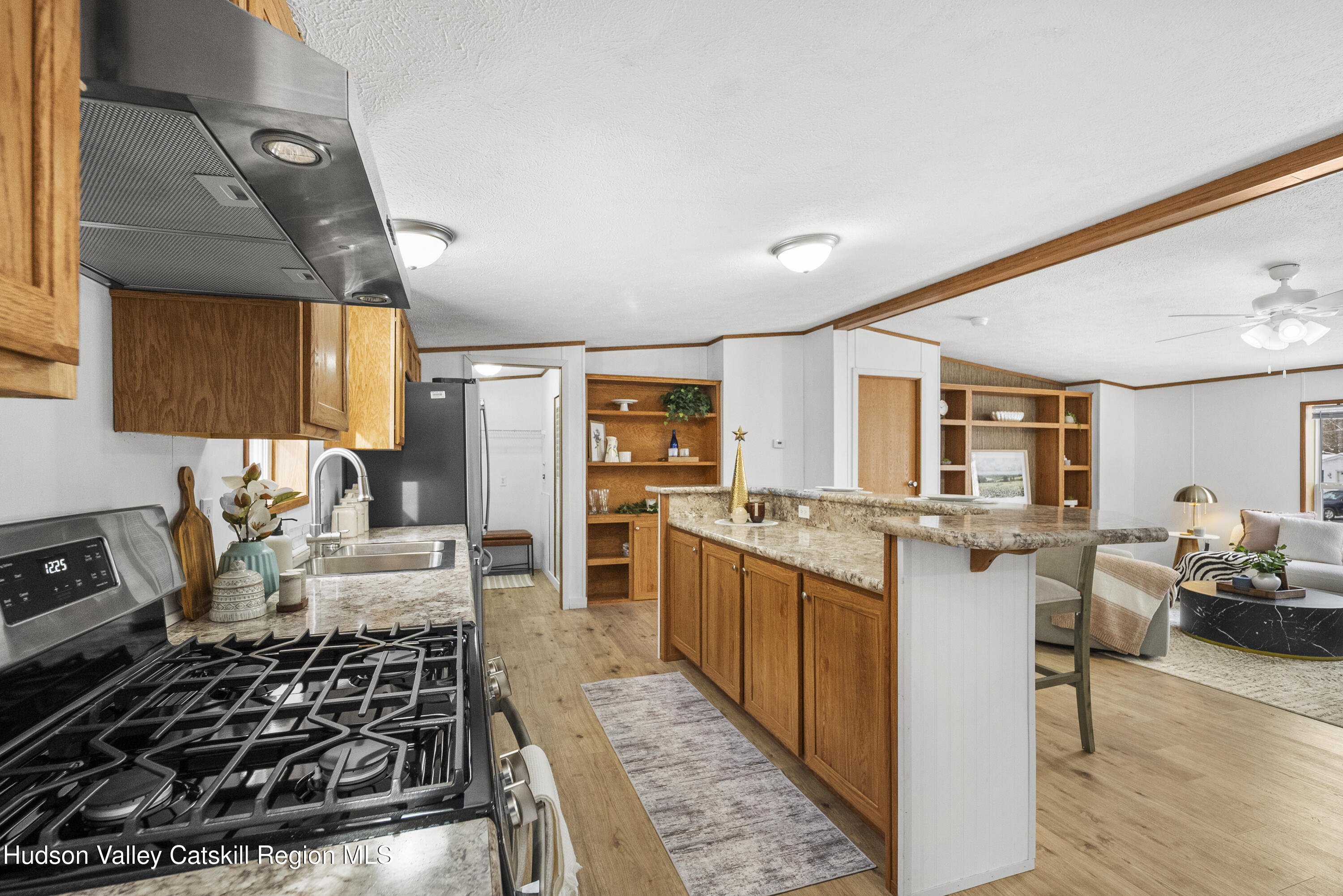 3701 Galway Road, Unit 5 Ballston Spa, NY 12020 - Photo 21 of 47 a living room with stainless steel appliances granite countertop furniture and a wooden floor