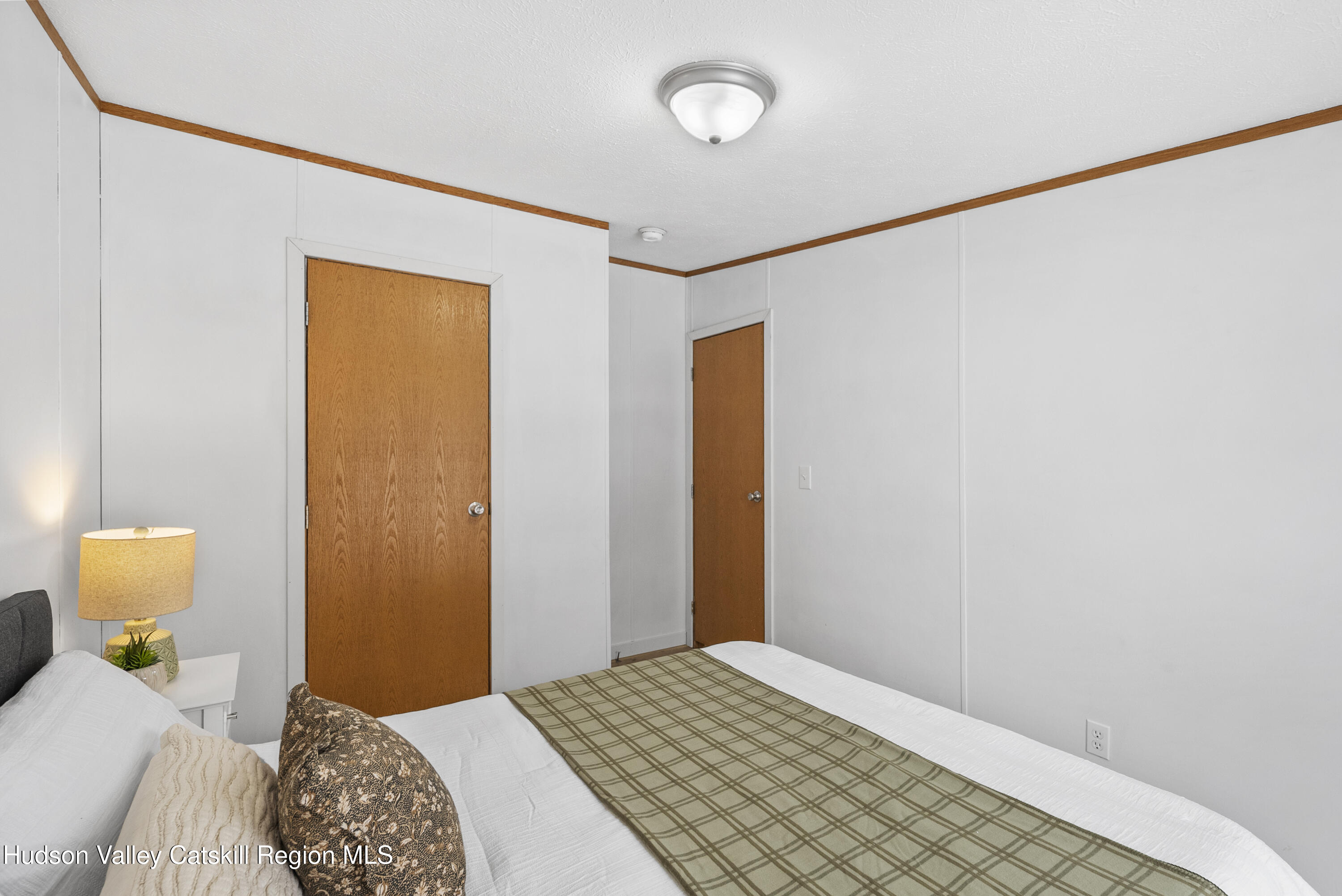 3701 Galway Road, Unit 5 Ballston Spa, NY 12020 - Photo 31 of 47 a bedroom with a bed and a lamp on the dresser