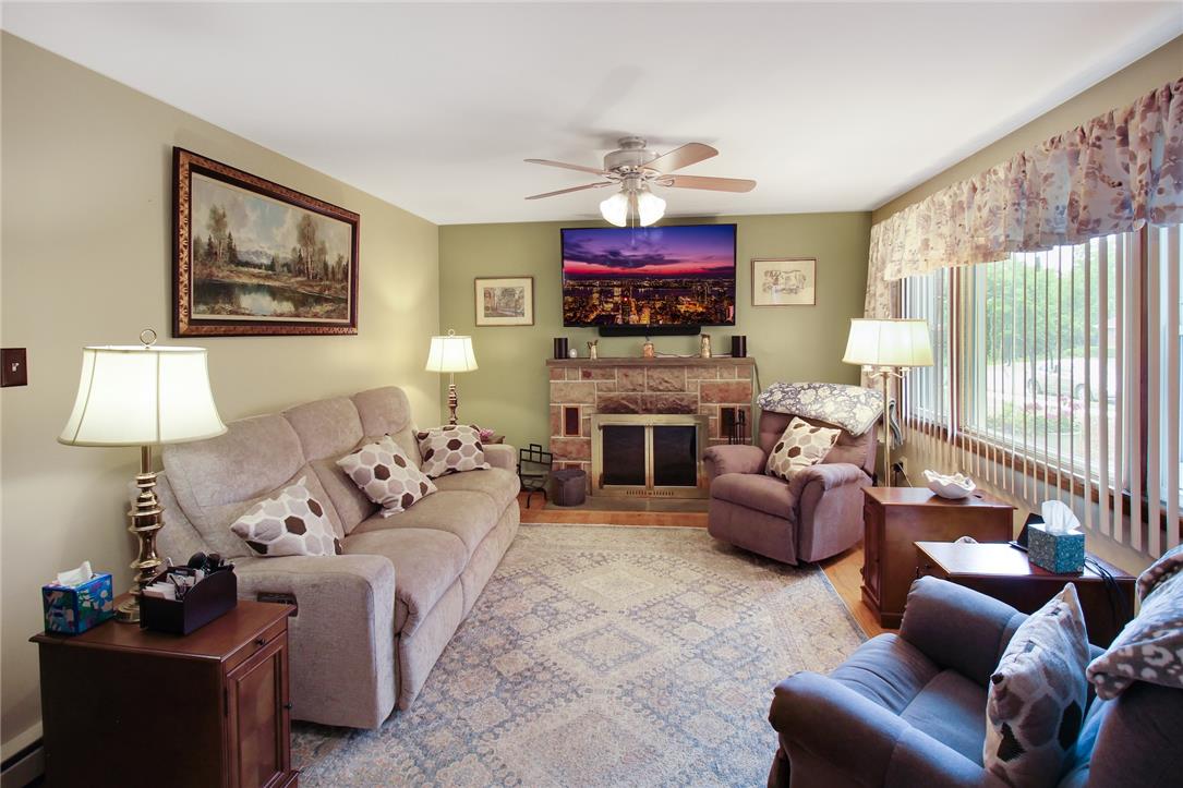 1256 Ridge Avenue Whitehall, PA 18052 - Photo 14 of 43 Relax in this comfortable living area, centered around a charming stone fireplace with a view of the outdoors.