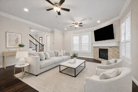 a living room with furniture a flat screen tv and a fireplace
