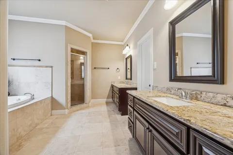 a spacious bathroom with a granite countertop tub sink and mirror