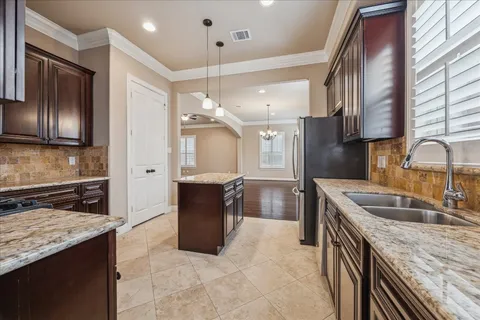 a kitchen with a sink stove and refrigerator