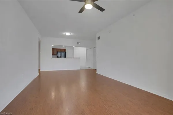 an empty room with a empty space and a ceiling fan