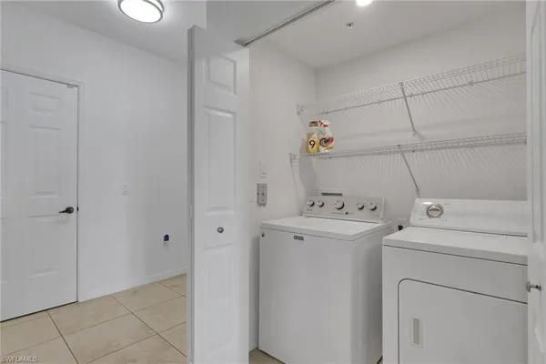 a view of storage and utility room with washer and dryer