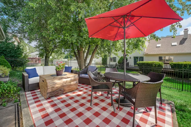 an outdoor space with furniture and umbrella
