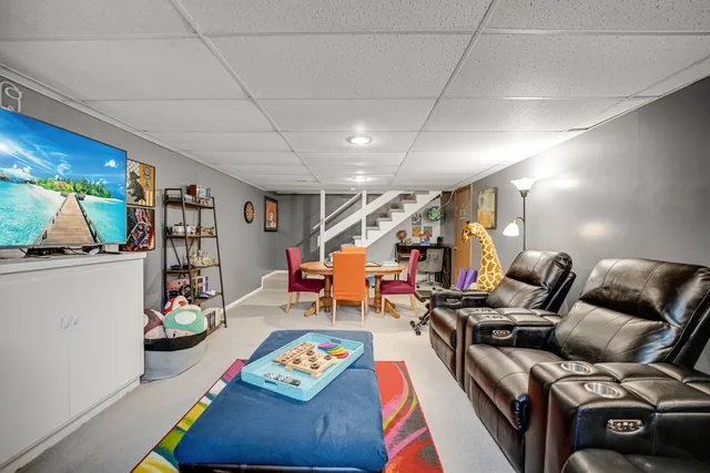 a living room with furniture and a gym equipment