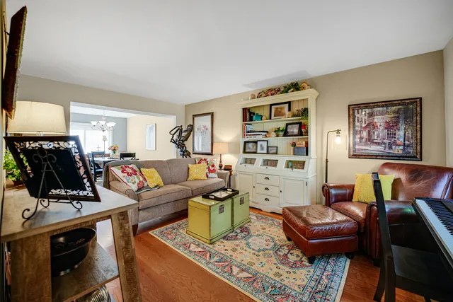 a living room with furniture a flat screen tv and a window