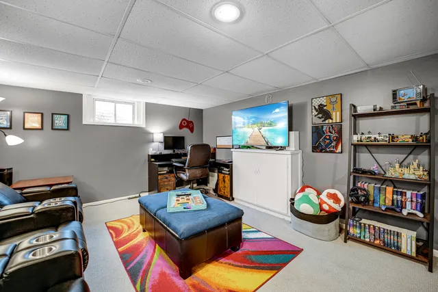 a living room with lots of furniture and book shelf