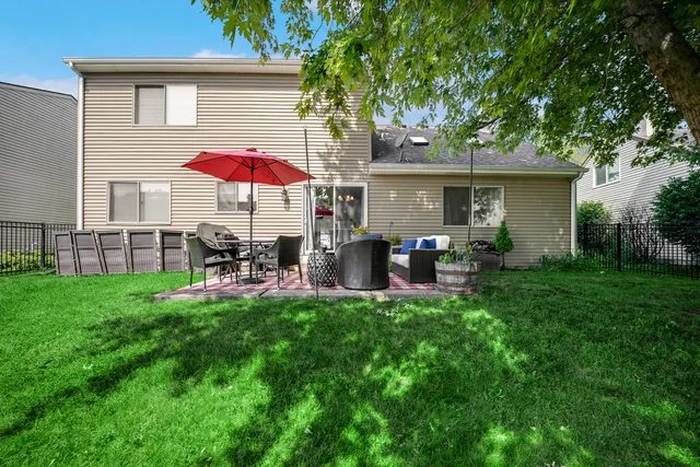 a view of a house with backyard sitting area and garden