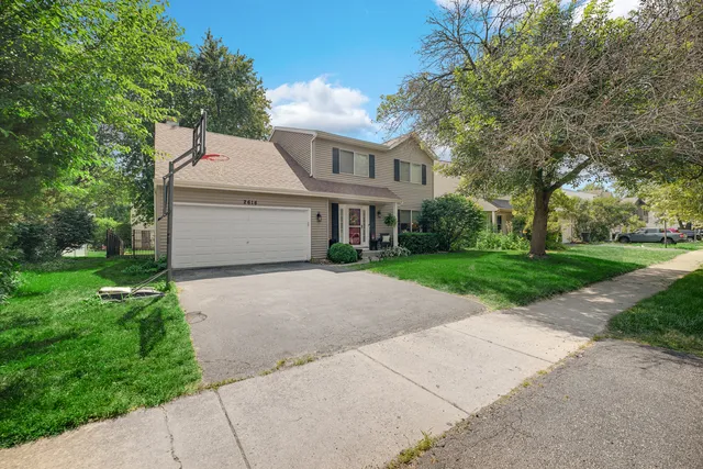 a front view of house with yard and green space