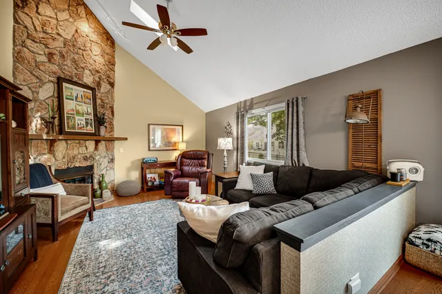 a living room with furniture fireplace and a window